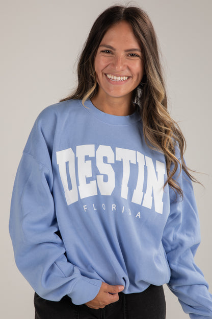 Woman wearing a blue sweatshirt with &