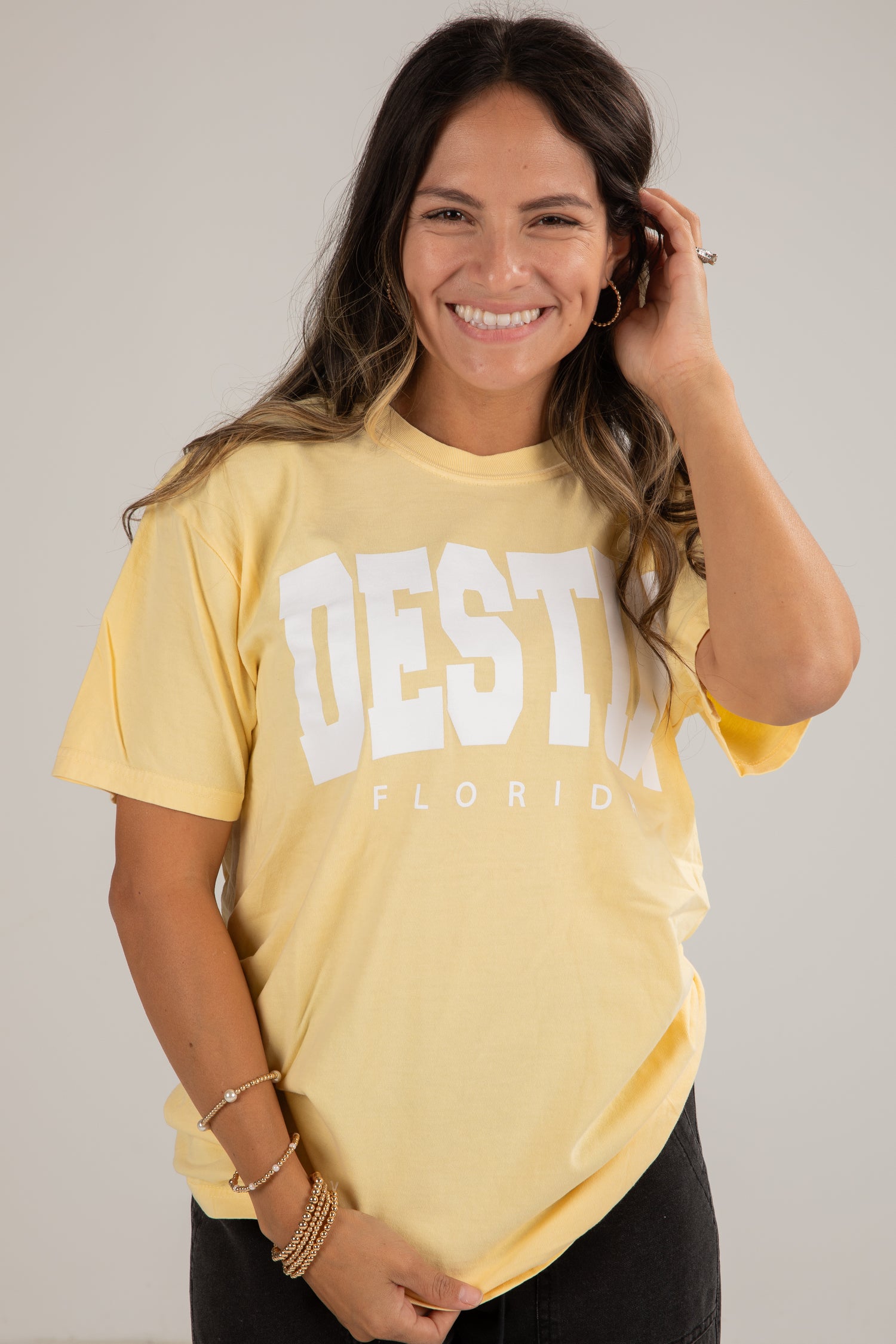 Woman wearing a yellow t-shirt with &