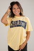 Woman wearing a yellow t-shirt with &