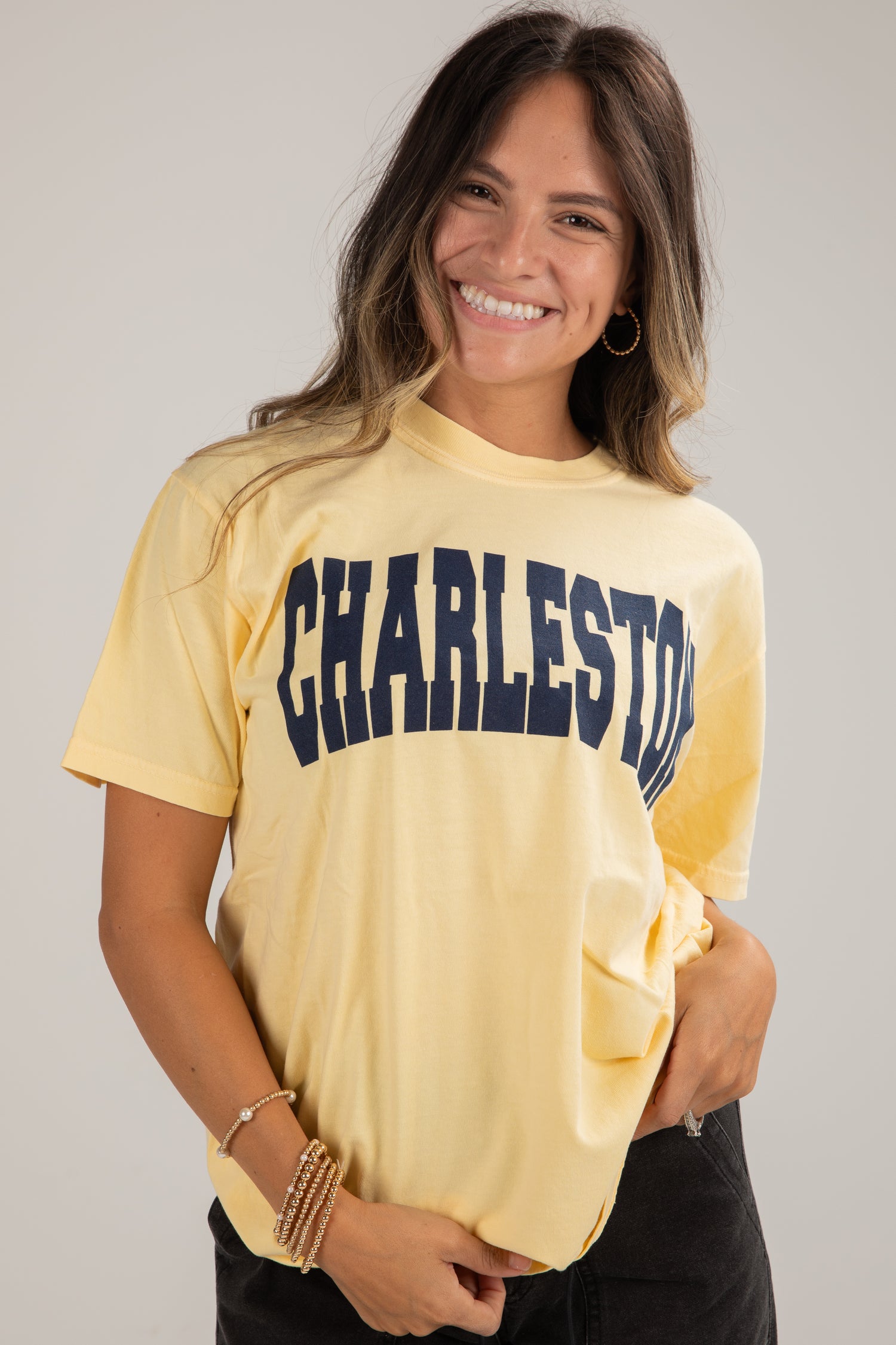 Woman wearing a yellow t-shirt with &