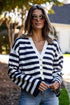 Woman wearing a navy and white striped cardigan outdoors