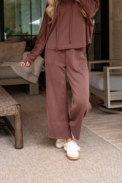 Person wearing a brown tracksuit in an indoor setting