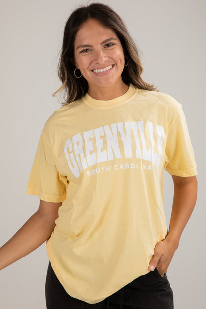 Woman wearing a yellow t-shirt with &
