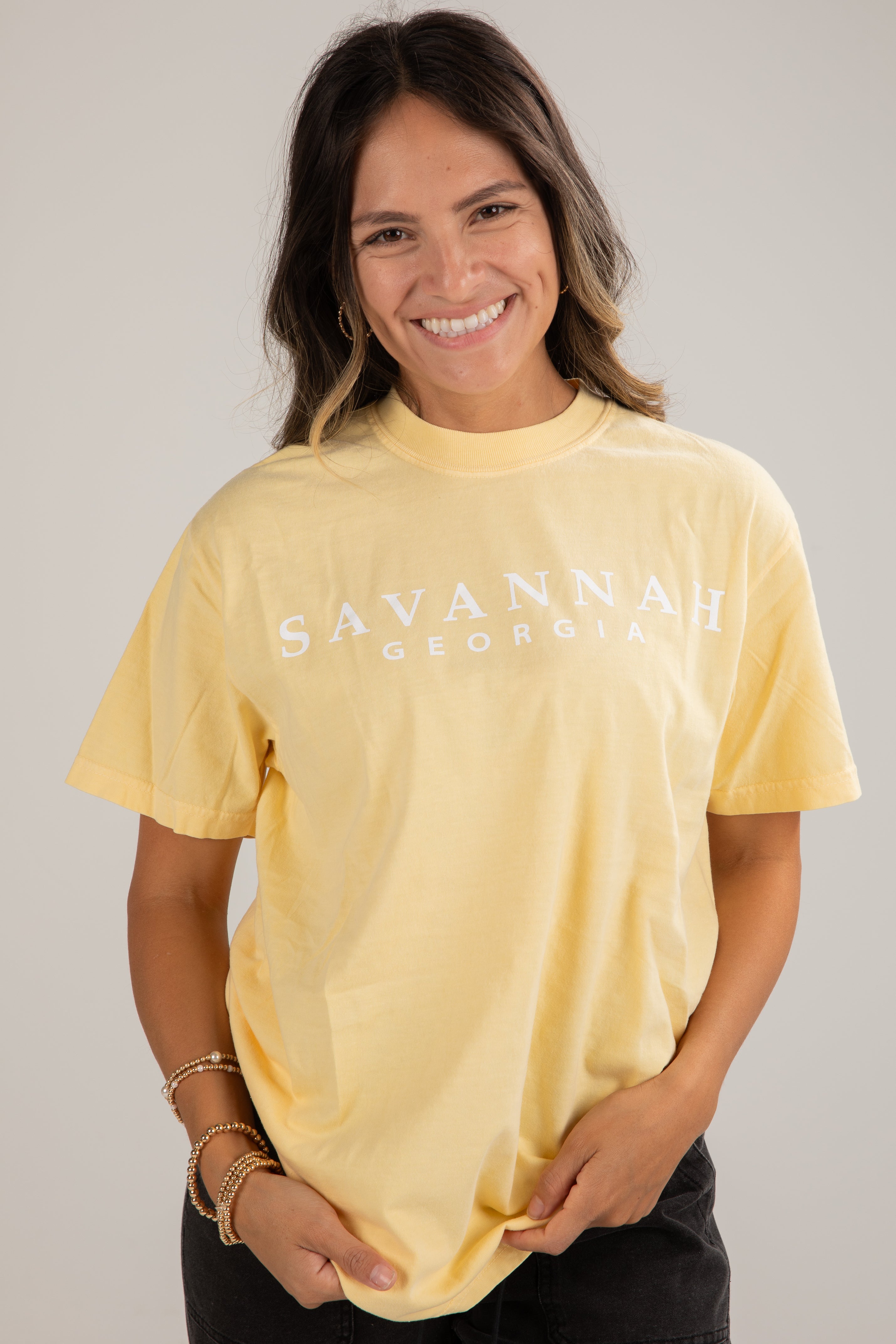 Woman wearing a yellow t-shirt with &