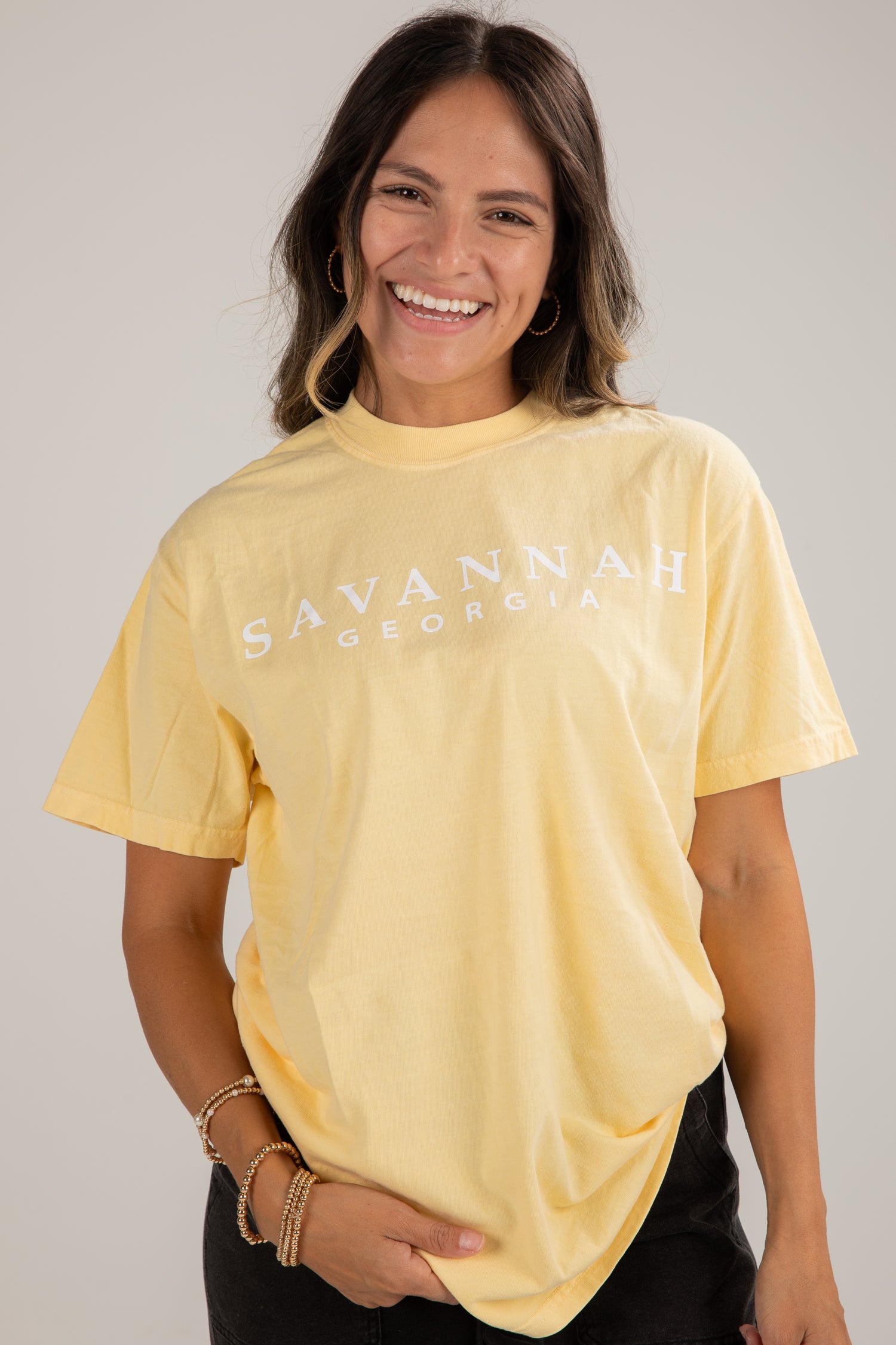 Woman wearing a yellow t-shirt with &