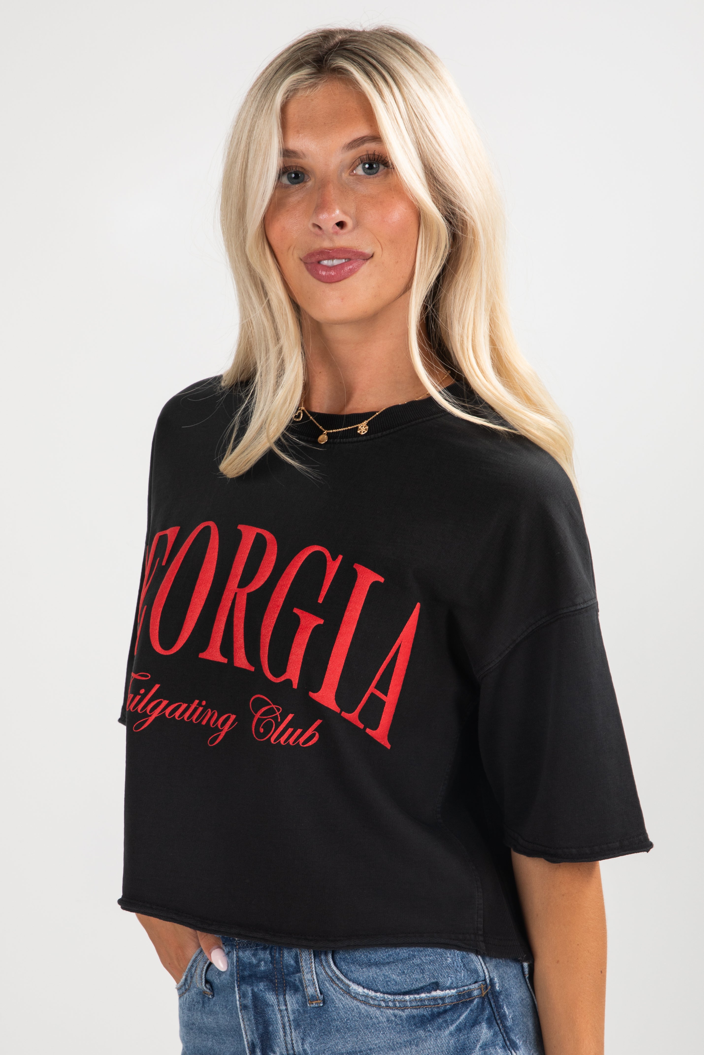 Person wearing a black t-shirt with red text on a white background