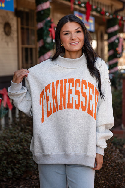 Person wearing a gray sweatshirt with &