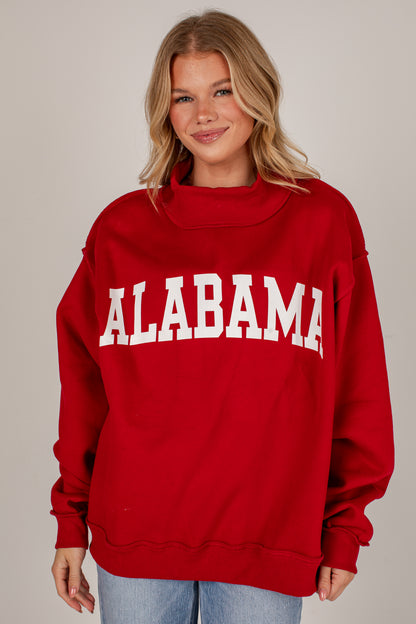 A woman wearing a red sweatshirt with &