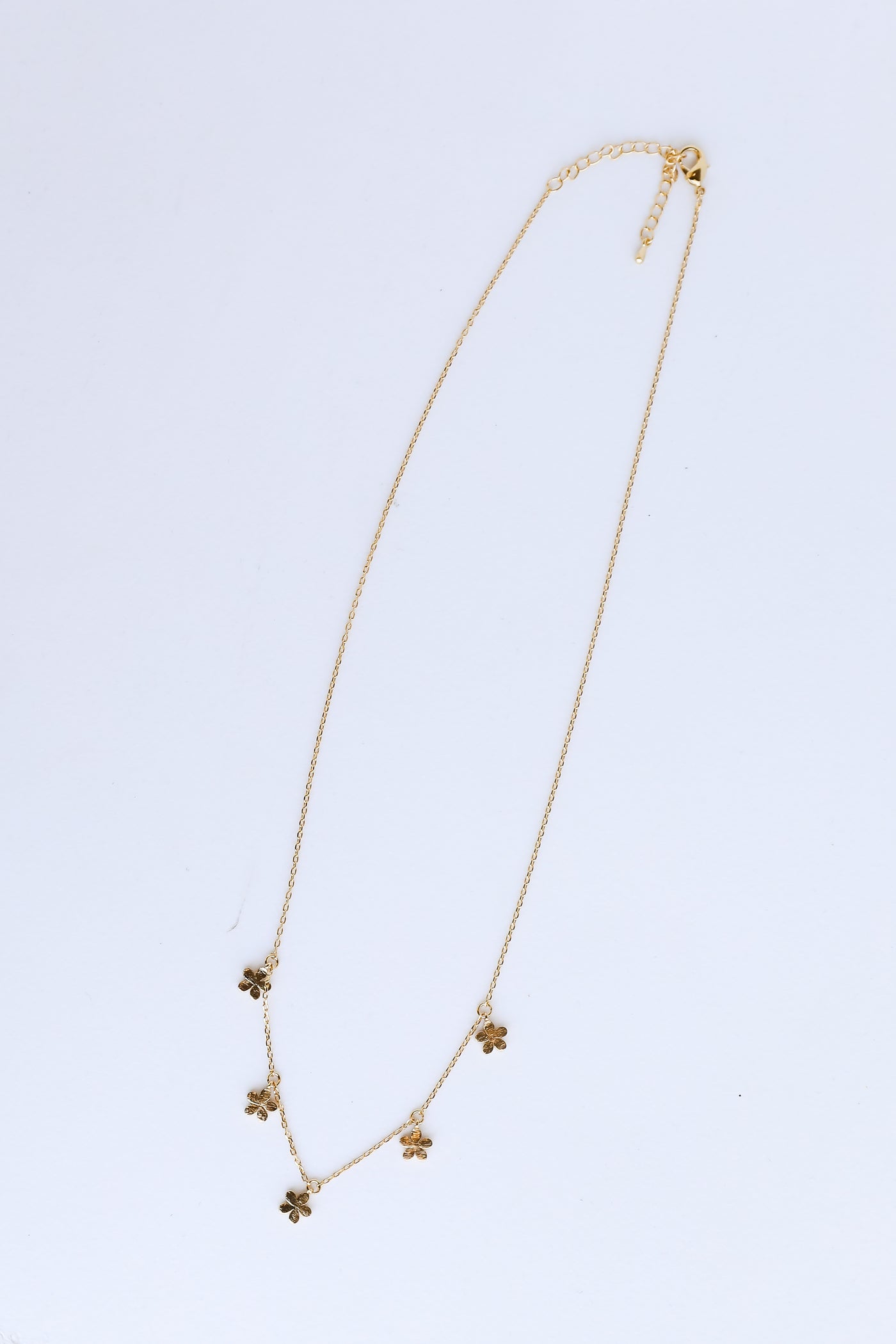 Gold Flower Charm Necklace flat lay