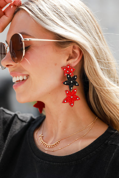 Red + Black Beaded Star Drop Earrings on model