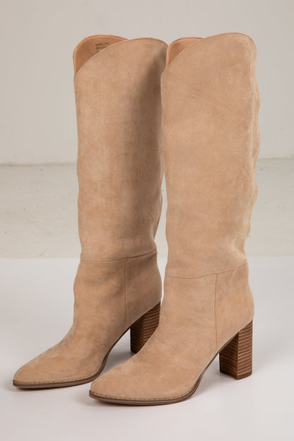 Pair of tan knee-high boots on a light gray background