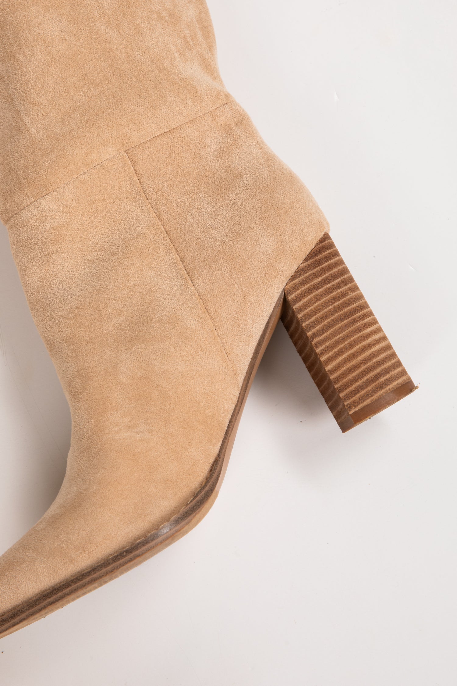 Tan suede knee-high boot with a block heel on a white background