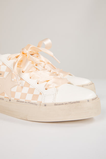 Pair of checkered sneakers on a light gray background