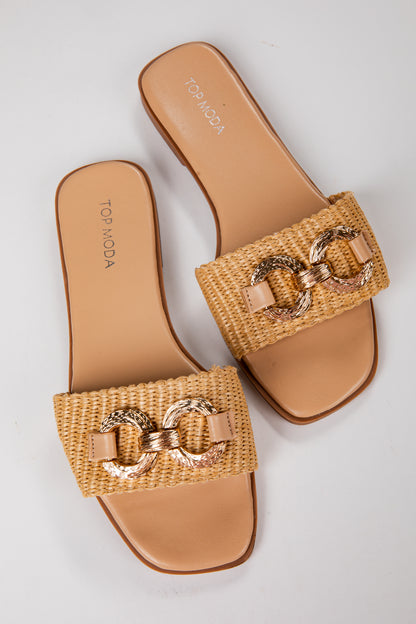Tan sandals with gold chain detail on a light gray background