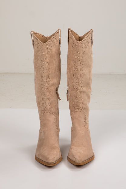 Pair of beige cowboy boots on a white background
