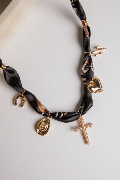 Necklace with gold charms on a white background