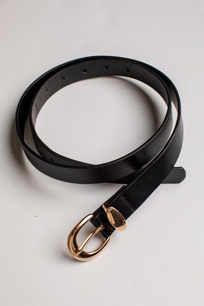 A black leather belt with a polished gold-tone metal buckle, coiled on a light gray background.