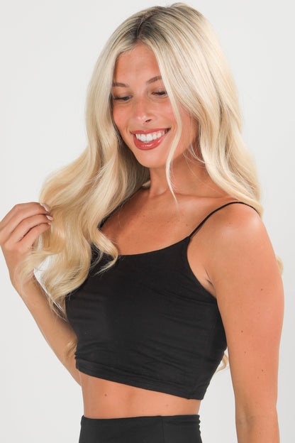 Woman wearing a black top against a white background