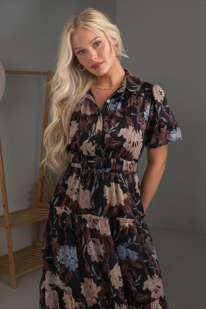 Woman wearing a floral dress against a neutral background