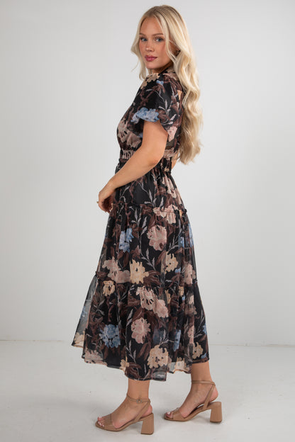 Woman wearing a floral dress on a plain background