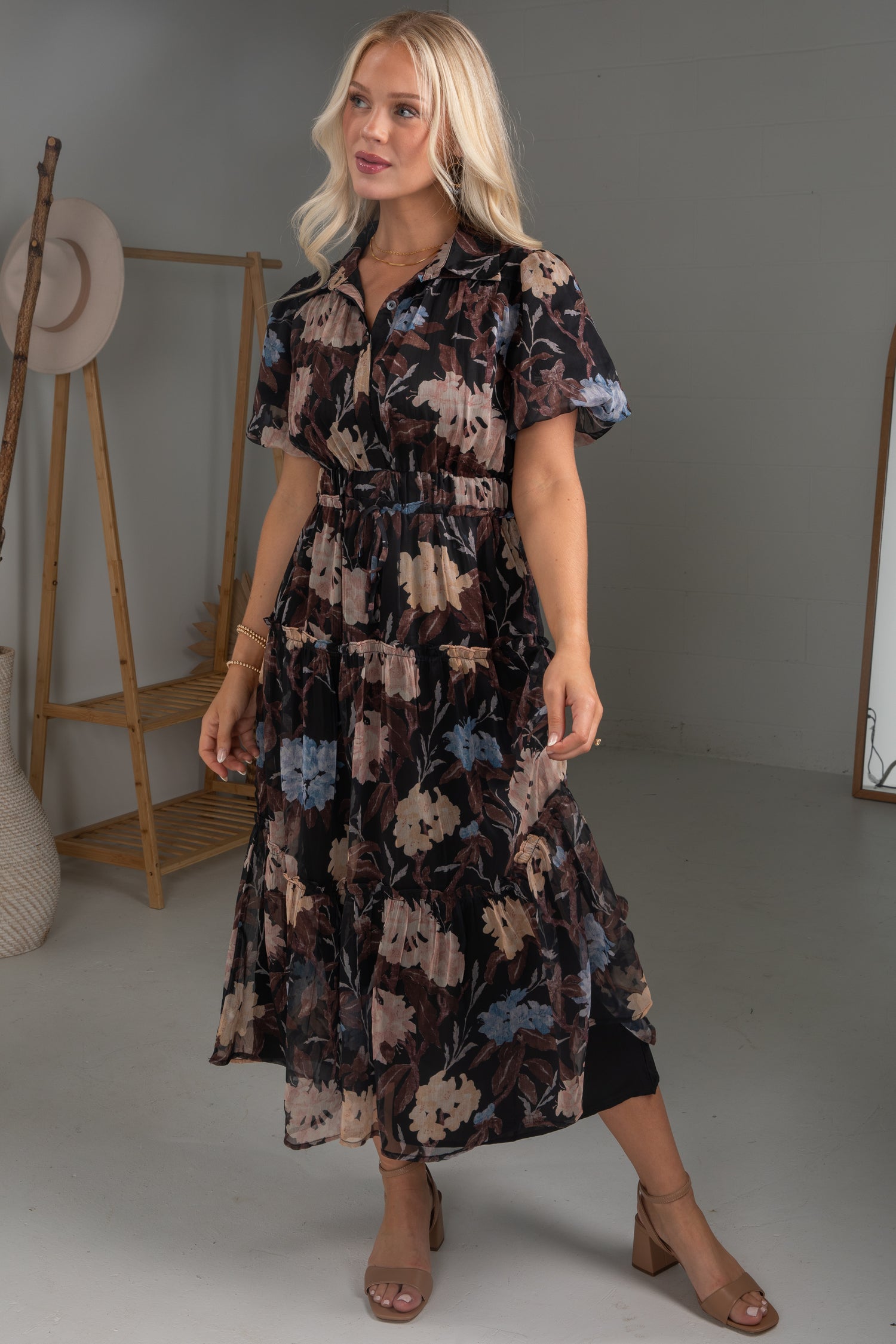 Woman wearing a floral dress in a studio setting