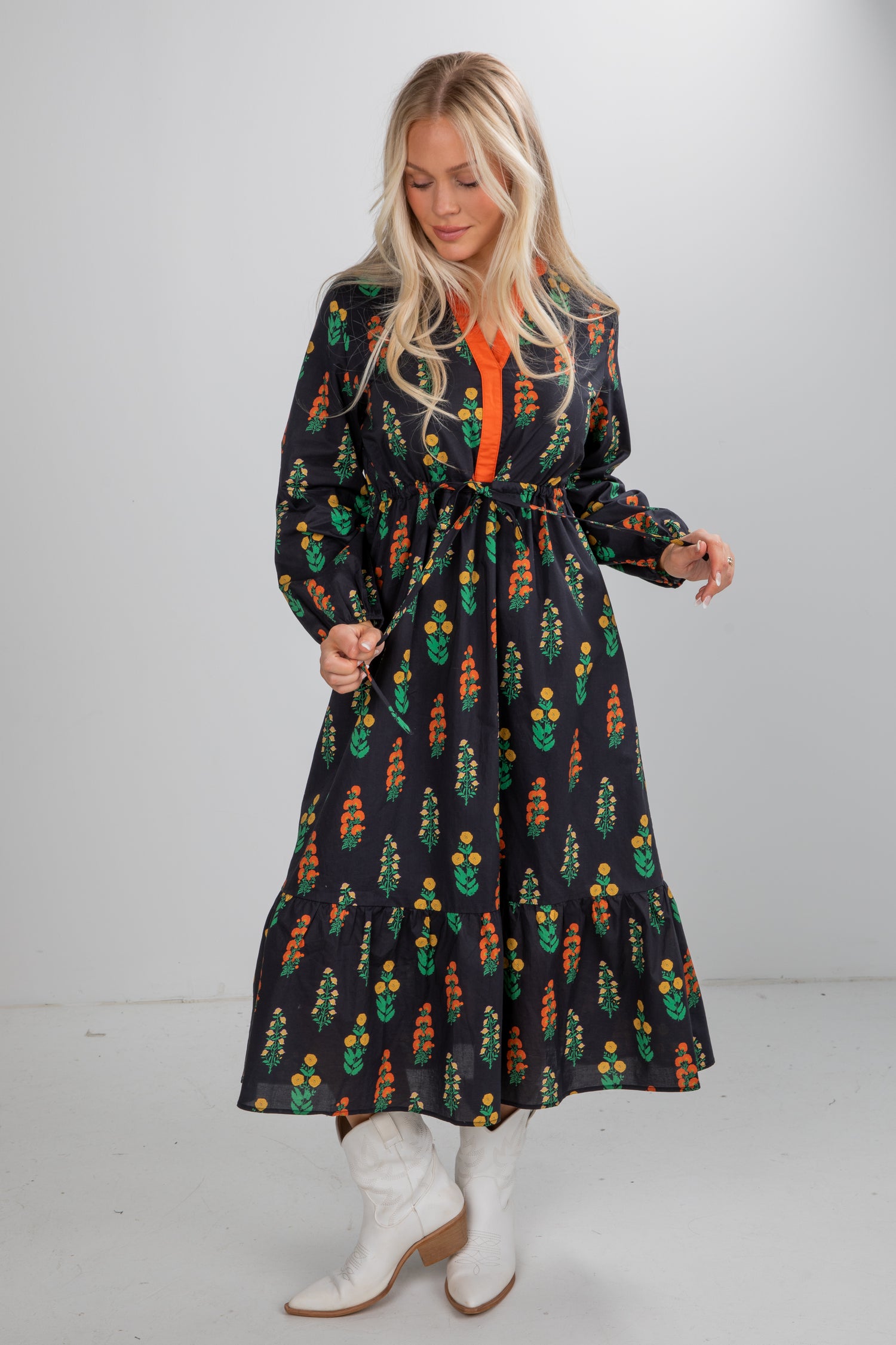 Woman wearing a patterned dress with a plain background