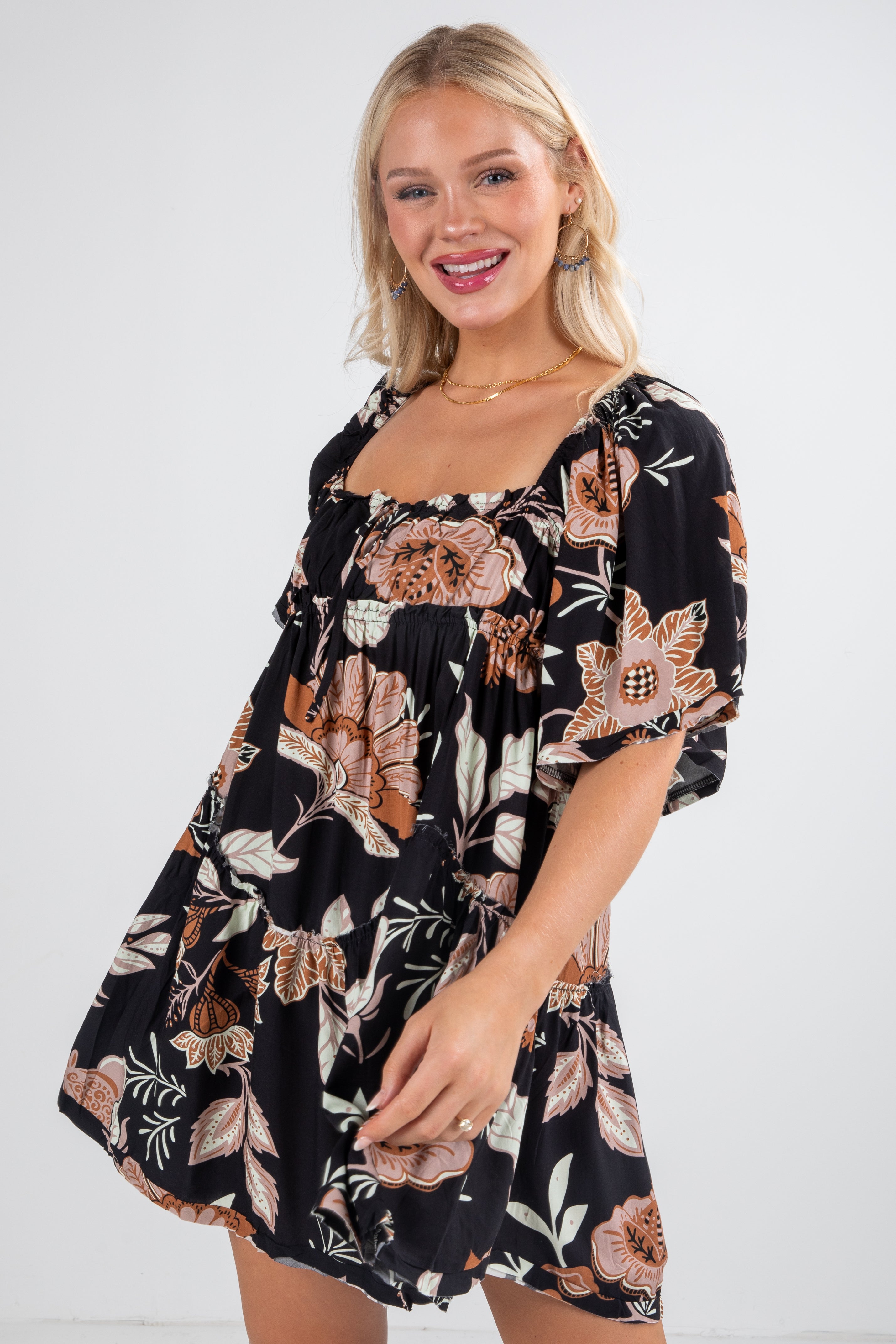 Woman wearing a black floral dress on a white background