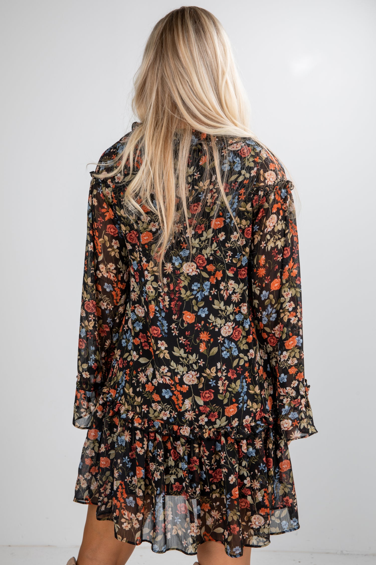 Floral dress worn by a person on a plain background