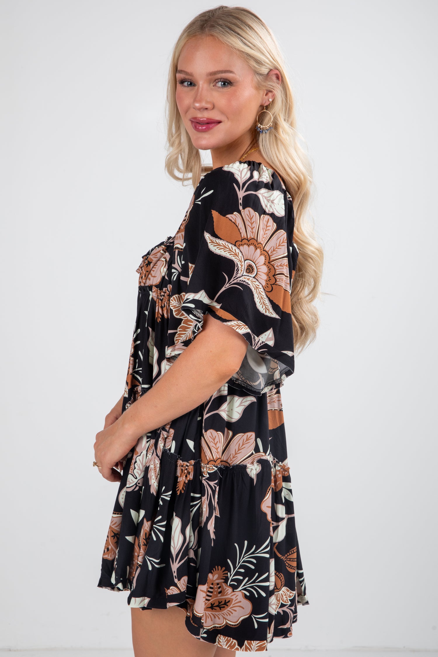 Woman wearing a floral dress with a plain background