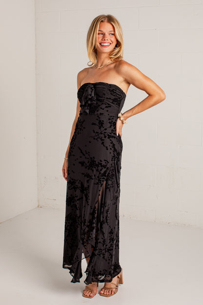 black midi dress features a tonal floral burnout design, delicate strapless fit, and a softly ruffled neckline