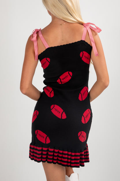 Black dress with red pattern and checkered straps worn by a model on a white background