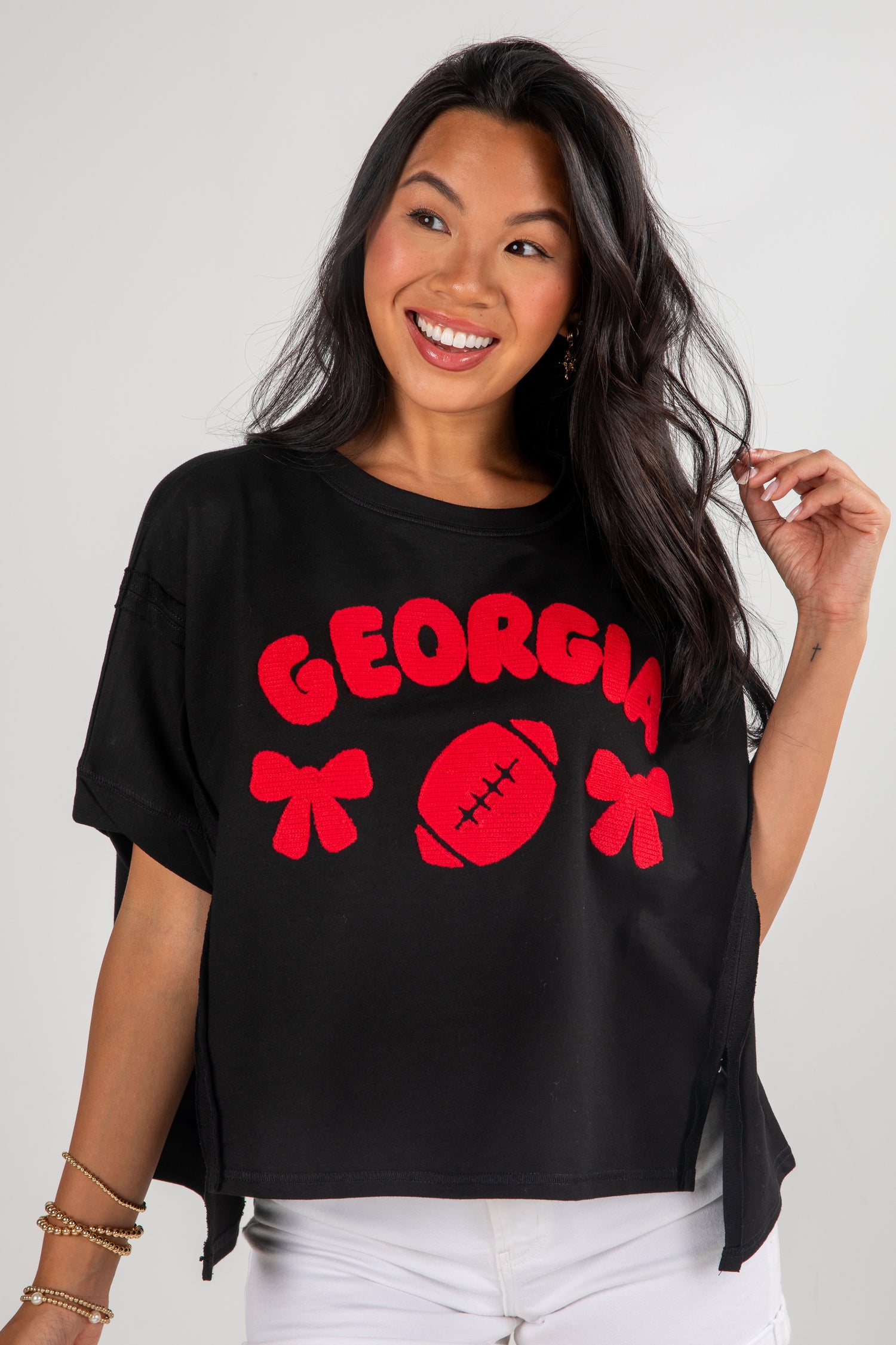 Woman wearing a black t-shirt with red &