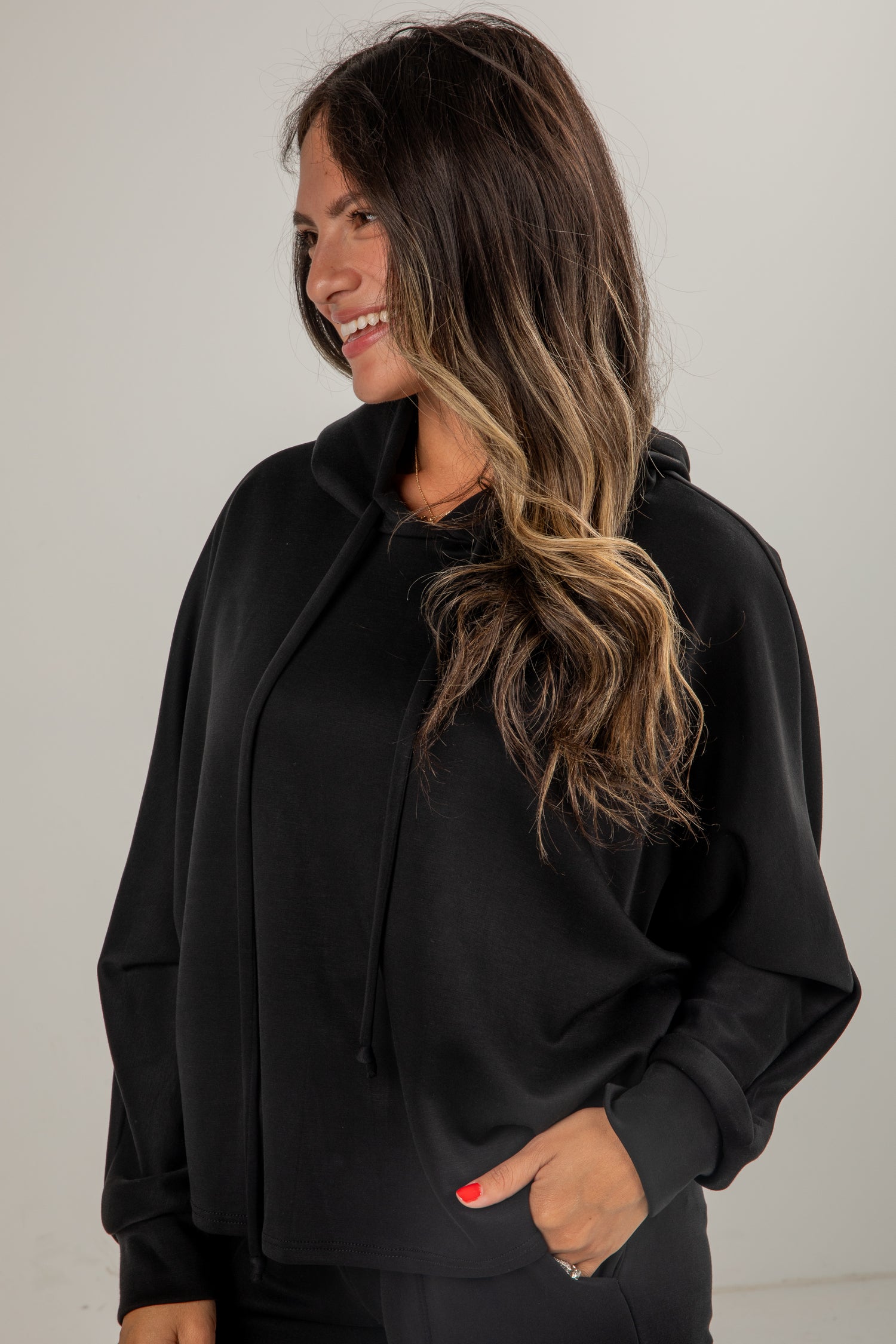 Woman wearing a black outfit with a plain background