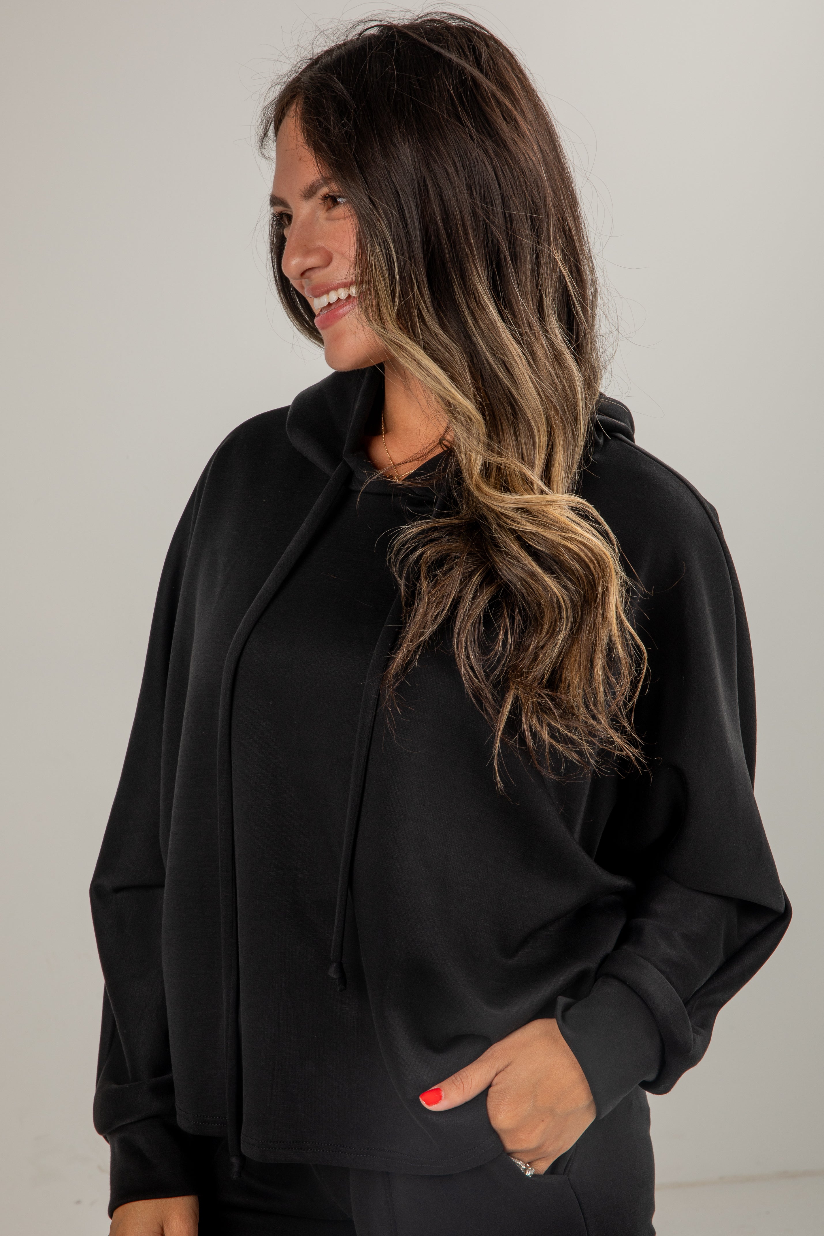 Woman wearing a black outfit with a plain background