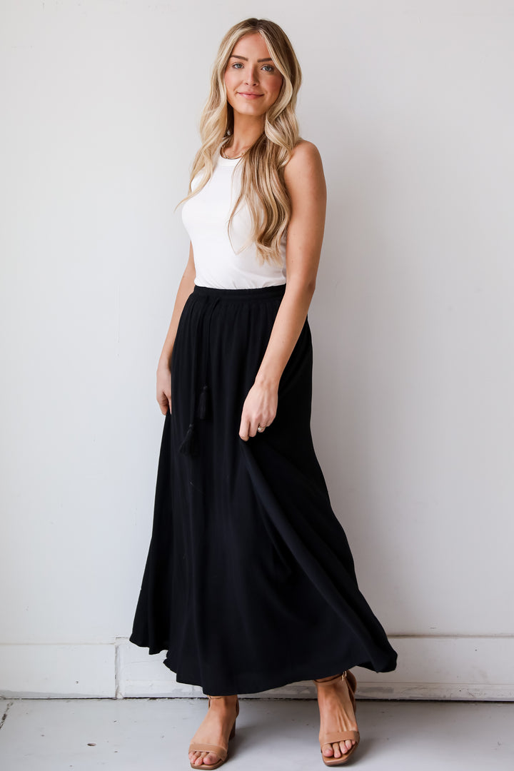 On My Mind Black Maxi Skirt has a flowy fit, elastic waistband, high-waisted skirt. Cute black skirt for summer. Pair with cute sandals, spring break outfit. online boutique 