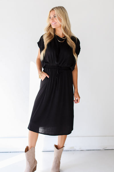 model wearing a black Midi Dress