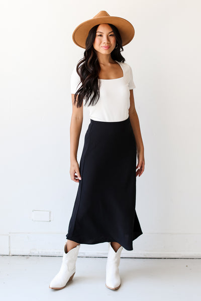 model wearing a black Midi Skirt