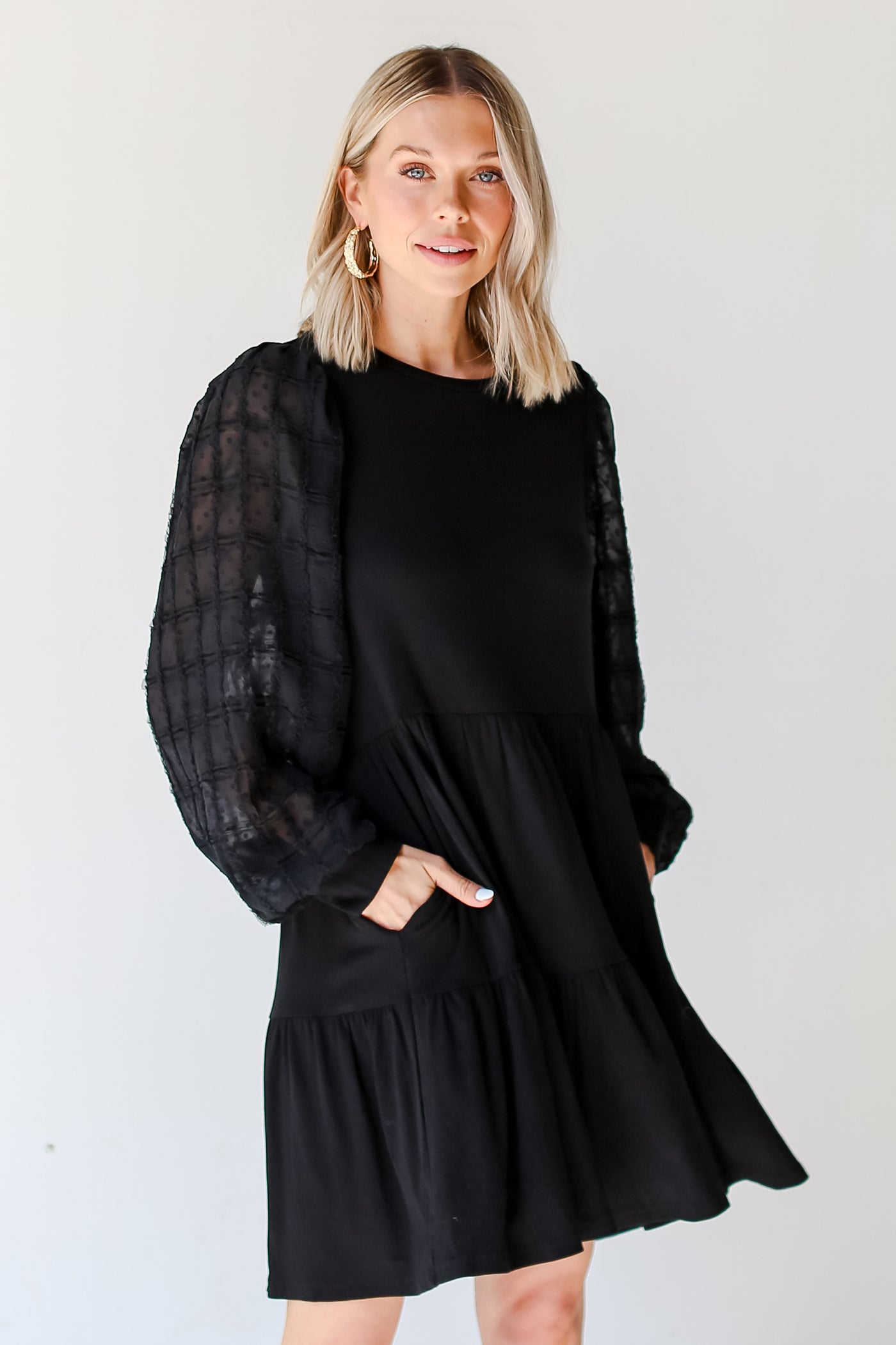 model wearing a black Tiered Mini Dress