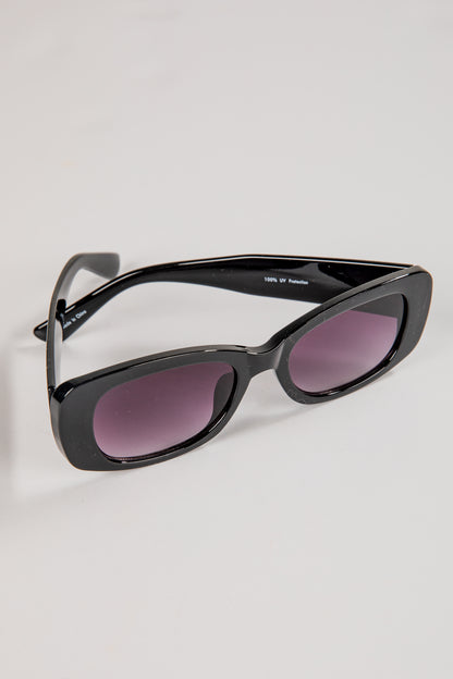 Black sunglasses with purple lenses on a light gray background