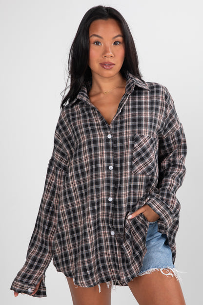 Woman wearing a plaid shirt and denim shorts on a white background