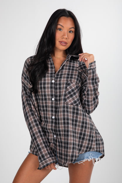 Woman wearing a plaid shirt against a white background