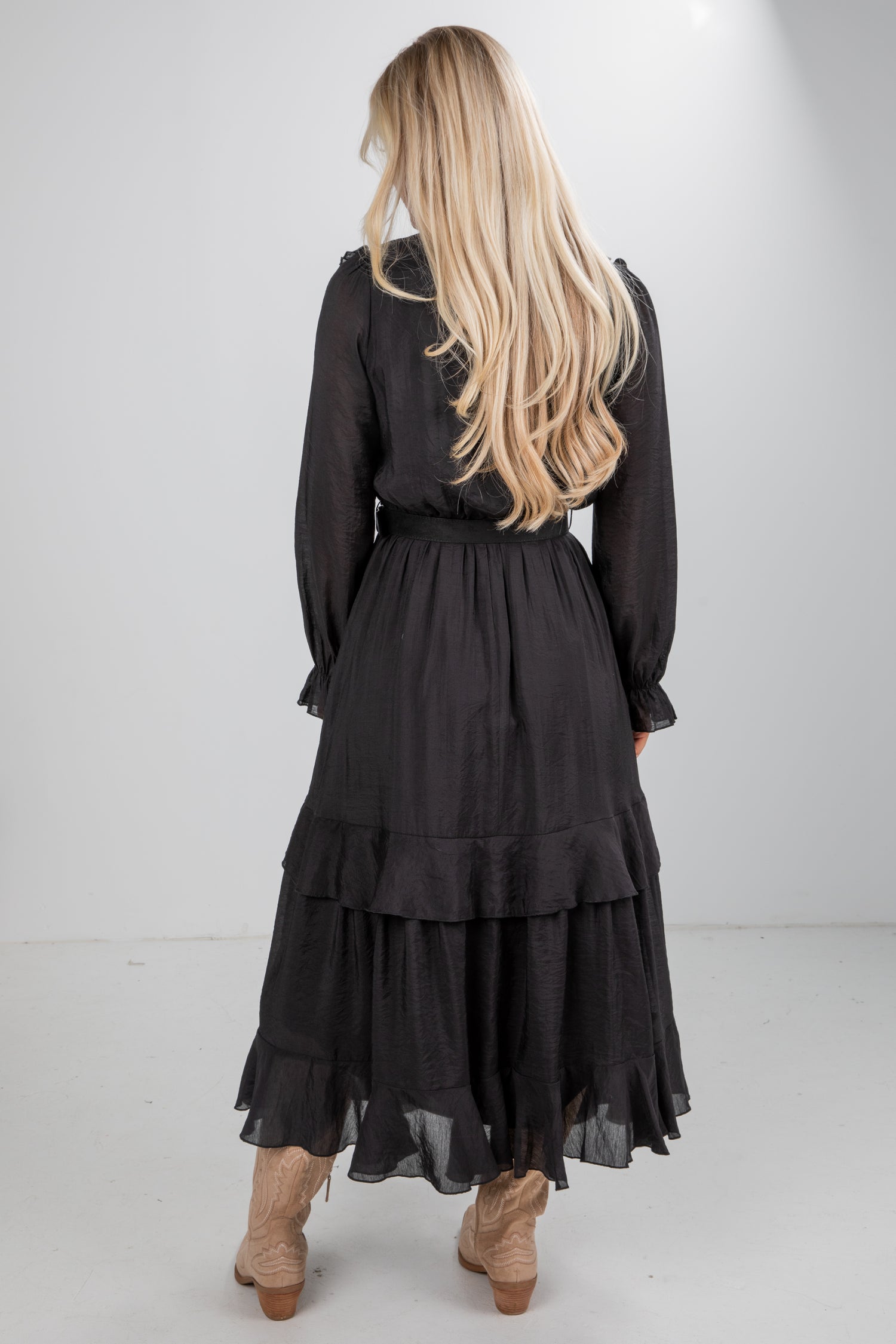 Person wearing a black dress with long hair on a white background