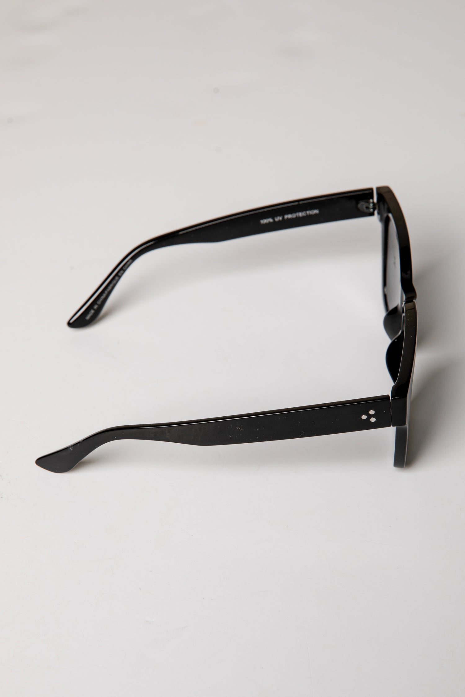 Black sunglasses on a light gray background