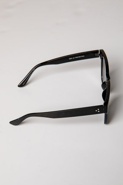 Black sunglasses on a light gray background