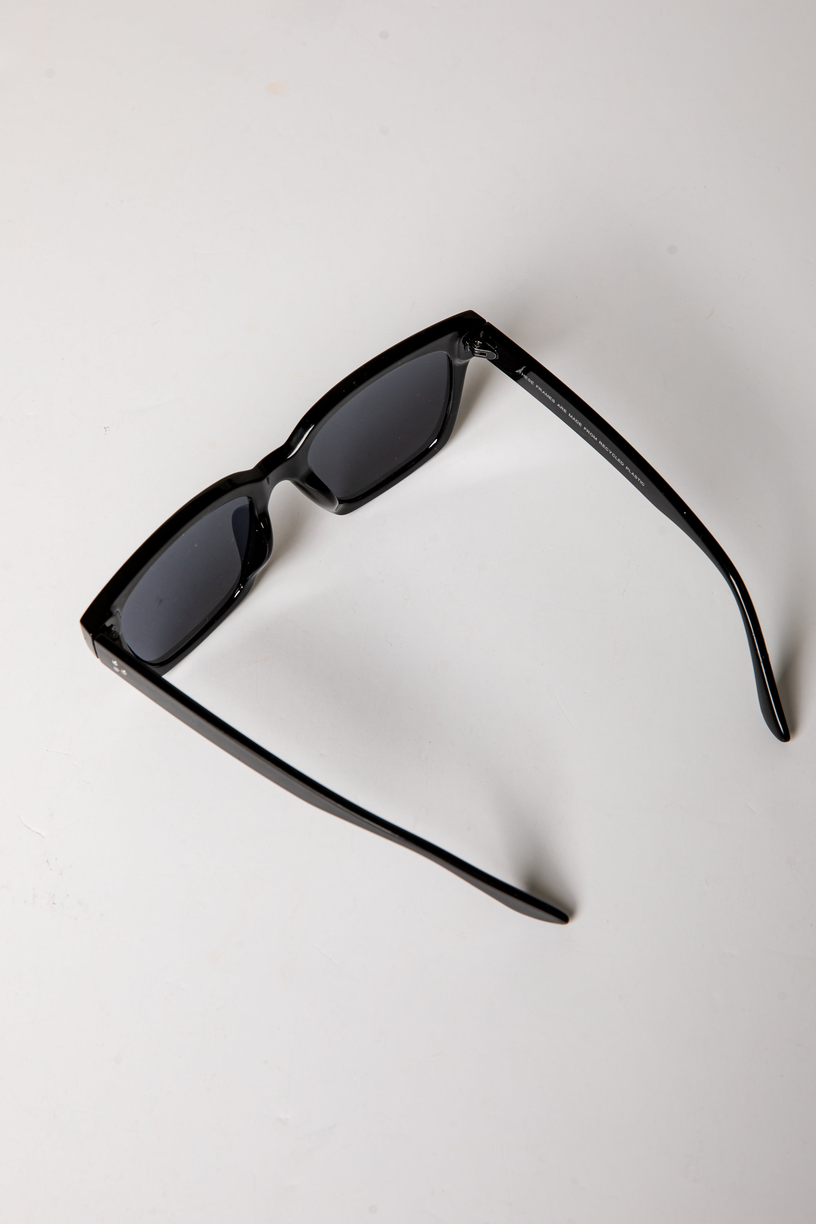 Black sunglasses on a light gray background