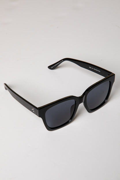 Black sunglasses with dark lenses on a white background