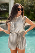 Woman wearing a black and white striped romper by a pool