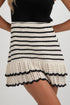 Black and white striped crochet skirt worn by a person on a plain background