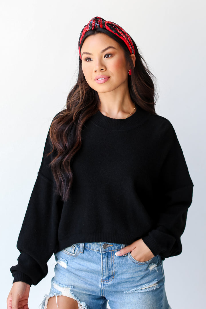 model wearing a black Sweater