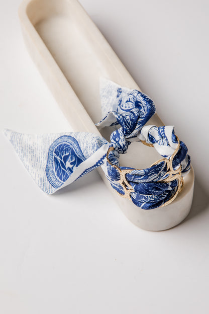 White ceramic candle holder with blue and white floral patterns on a white background